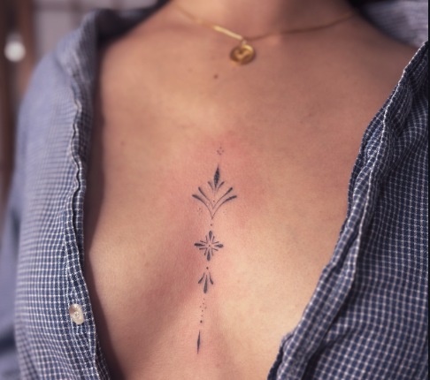 Delicate vertical sternum floral tattoo